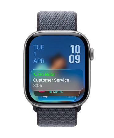 Apple Watch in Space Gray with Gray Band, Face shows Hold assist notification at bottom, date on top left, time numerals stacked at top right